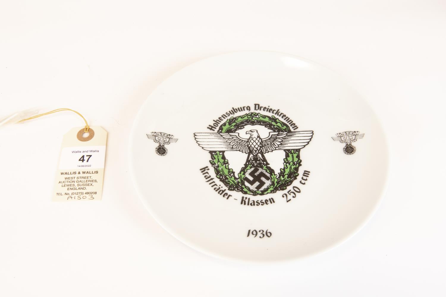 A Third Reich china plate motoring award, 125mm diameter, eagle and swastika motif surrounded by "