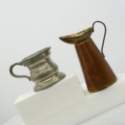 A vintage pewter drinking vessel with a brass and copper jug
