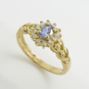 A 9ct yellow gold tanzanite and diamond ring with heart shoulders