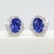 A large pair of loupe-clean tanzanite and diamond cluster earrings in 18ct white gold, certificated