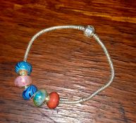 A Pandora style silver bracelet with charms.