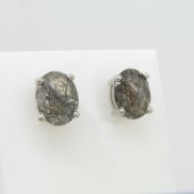 A pair of unusual silver ear studs set with natural black rutilated quartz