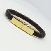 A woven-style leather effect and yellow metal bracelet with USB style fastening