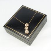 A continental-style 14ct rose gold necklace with a 1.00ct diamond triple cluster pendant and gift bo