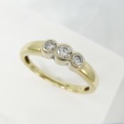 A 0.25ct bezel-set graduated diamond trilogy ring in 9ct yellow gold