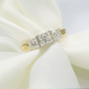 An 18ct yellow and white gold 1.00ct graduated 3-stone princess-cut diamond ring