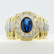 A gold plated silver gent's ring set with blue and white stones, with watch bracelet style shoulders