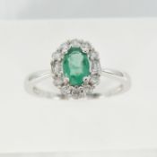 A classic-style oval emerald and diamond halo ring in 18ct white gold, certificated