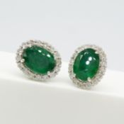 A pair of 3.50ct emerald and 0.63ct diamond cluster stud earrings in 18ct white gold, boxed