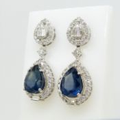 An exquisite pair of continental-style tear drop sapphire and diamond drop earrings in 18ct white go