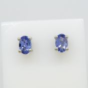 A pair of oval tanzanite gemstone stud earrings in silver