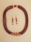 A Three Strand Necklace and Earrings Set With Rubies and Pink Pearls.
