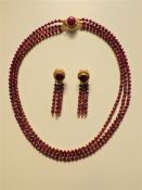 A Three Strand Ruby Necklace and Earrings Set.