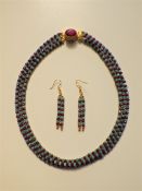 A Three Strand Emerald and Ruby Necklace With Matching Earrings.