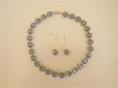 A Grey Cat'S Eyes Necklace and Earrings Set.