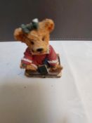 Bear on case with red dress