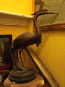 A Bronze Crane Sitting on a Base