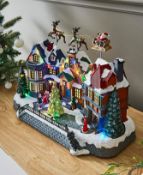(97) Christmas Musical Village Scene With Flying Santa & Sleigh. Mains Operated. Dimensions: (H39...