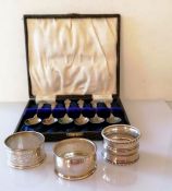 A George V cased set of six silver coffee spoons by Harrods Ltd., London, 1926 and three silver napk