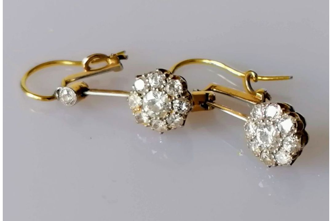 A pair of white and yellow metal diamond earrings, the central round-cut diamond approximately 0.20 - Image 2 of 6