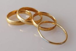 Three yellow gold wedding bands, another with platinum, all hallmarked 22ct, sizes N, Q, R, R, 11.77