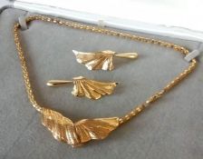 A 9ct yellow gold necklace and earrings, designed as a snake link chain suspending a scroll detail w