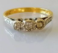 A gold three-stone diamond illusion-set ring, size M, stamped 18ct, 3.2g