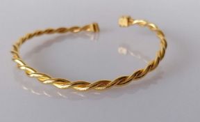 A Middle-East gold rope-twist bangle, stamped and tests for 22ct, 25g