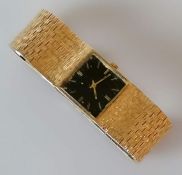A vintage Marvin black face square dial watch with baton markers, 23mm, with a textured gold bark ef