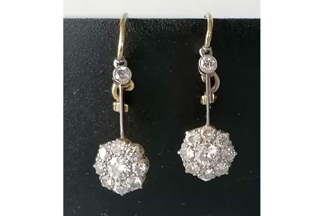 A pair of white and yellow metal diamond earrings, the central round-cut diamond approximately 0.20 - Image 3 of 6