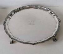 A George VI silver salver with etched decoration to pie-crust border on four claw and ball feet by R
