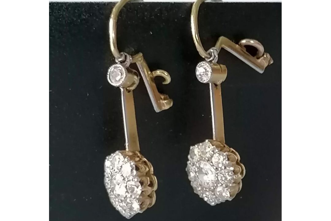 A pair of white and yellow metal diamond earrings, the central round-cut diamond approximately 0.20 - Image 5 of 6