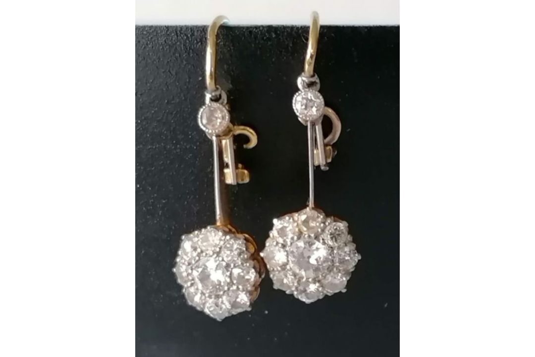 A pair of white and yellow metal diamond earrings, the central round-cut diamond approximately 0.20 - Image 4 of 6