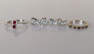 An 18ct white gold ruby and diamond crossover ring, the princess-cut rubies approximately 0.24 carat