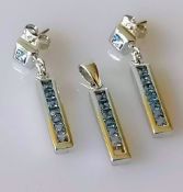 An 18ct white gold channel-set blue topaz pendant (one stone missing) and a pair of matching