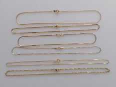 An assortment of yellow gold neck chains/chokers, various sizes/styles, all stamped 750, all
