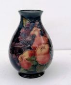 A Moorcroft 'Finches' pattern vase, tubelined with birds against a dark blue ground, impressed and