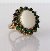 An opal and emerald cluster ring on a 9ct yellow gold setting, the opal 20mm x 12mm, showing pink