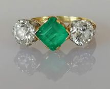 A three-stone emerald and diamond ring, the central square step-cut emerald approximately 6.60 x 6.