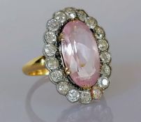 A late Victorian morganite and diamond cluster ring, the central oval-cut morganite 16.17 x 9.18 x
