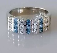 An 18ct white gold blue topaz and cubic zirconia ring, size N, hallmarked, 6g