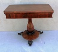 A George IV rosewood fold over card table with shaped top, plain frieze, octagonal baluster support
