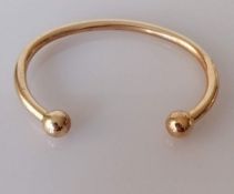 A 9ct yellow gold torc bangle, 65mm internal width, hallmarked, 30.88g
