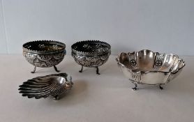 A late Victorian silver butter dish in the form of a scallop on ball feet, hallmarked for Mappin & W
