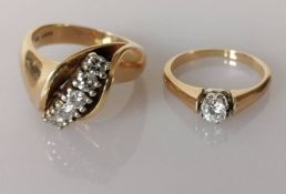 A stylised diamond ring set with five brilliant-cut diamonds in an open style fluted head