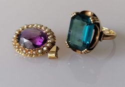 An Edwardian oval amethyst pendant with seed pearl decoration on a yellow gold setting