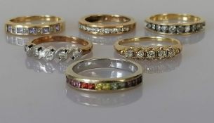 A tanzanite and diamond half-hoop eternity ring, set with five square step-cut tanzanites,