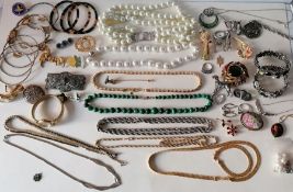 A selection of mixed costume jewellery to include bead necklaces, brooches, bangles, rings, etc