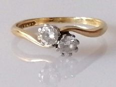 A two-stone diamond crossover ring in a 18ct yellow gold and platinum claw setting