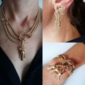 A gold parure comprising necklace with triple strand rope-twist chain, integrated scrolls